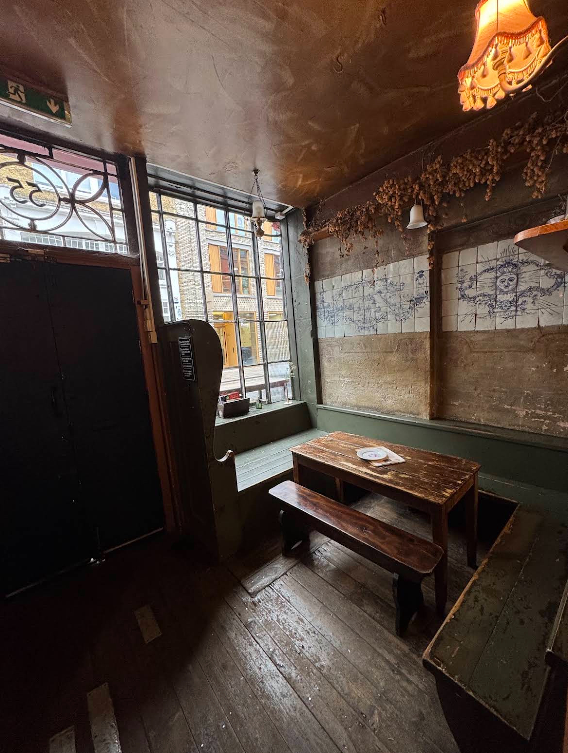 A dark, candle-lit corner of the tavern